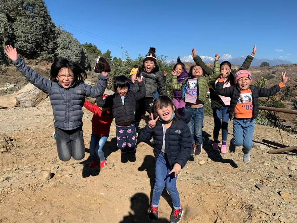 May be an image of 5 people, child, people standing, outerwear and tree