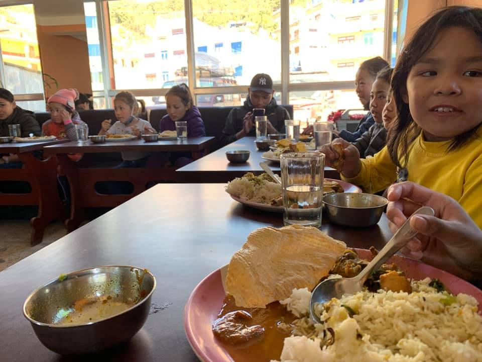 May be an image of 3 people, people sitting and food